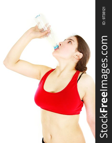 Young attractive girl drinking water over white