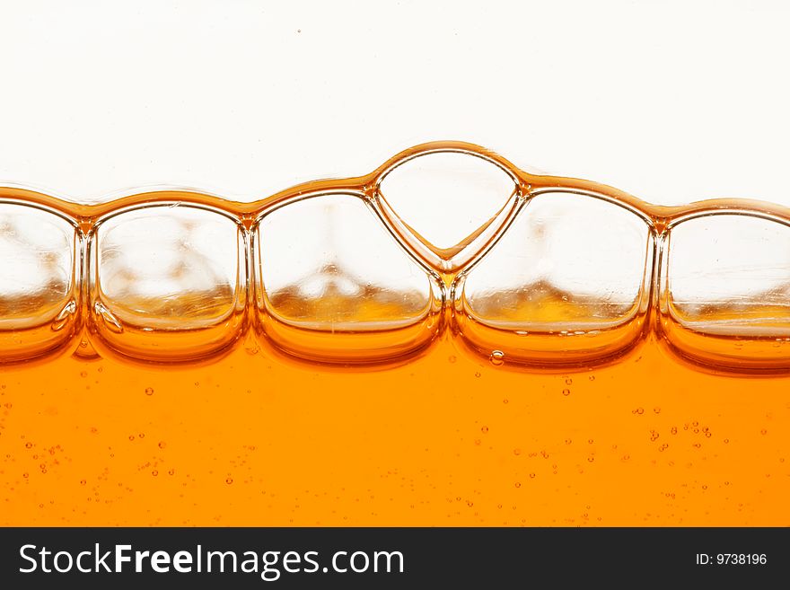 Macro of orange bubbles against white background