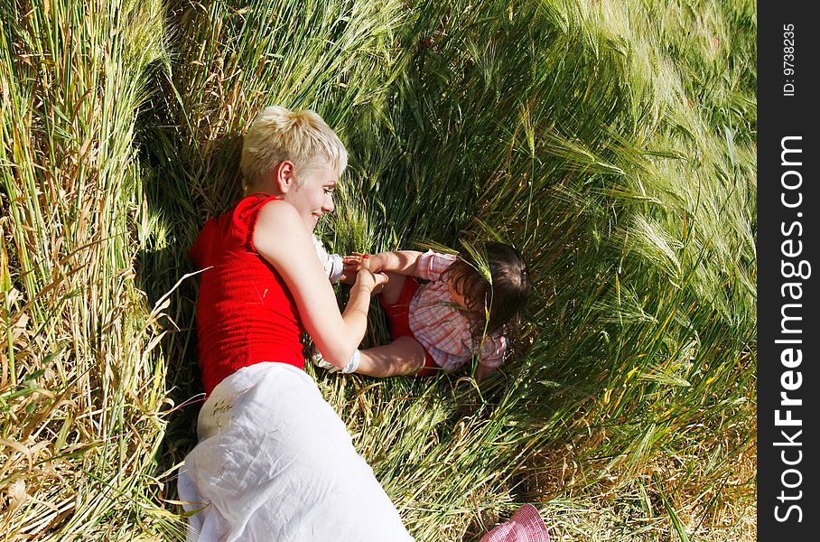 Happy mother and daughter in green field