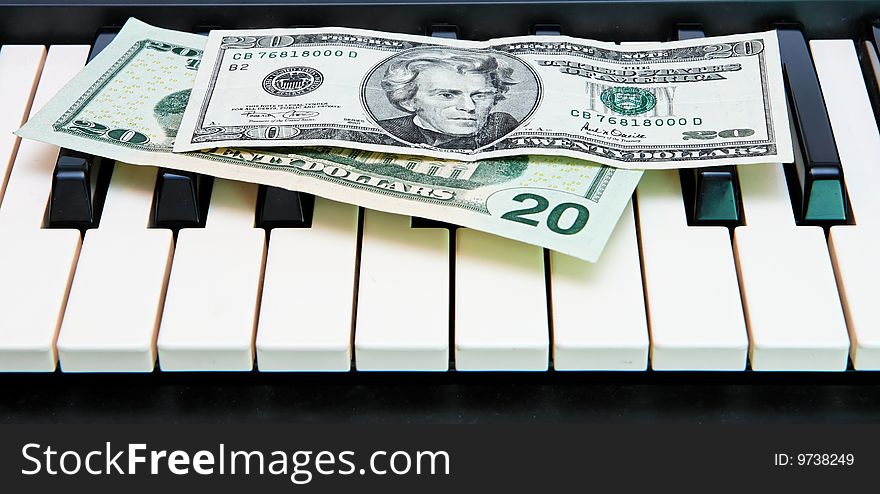 Dollar Bills On Electric Organ Keyboard