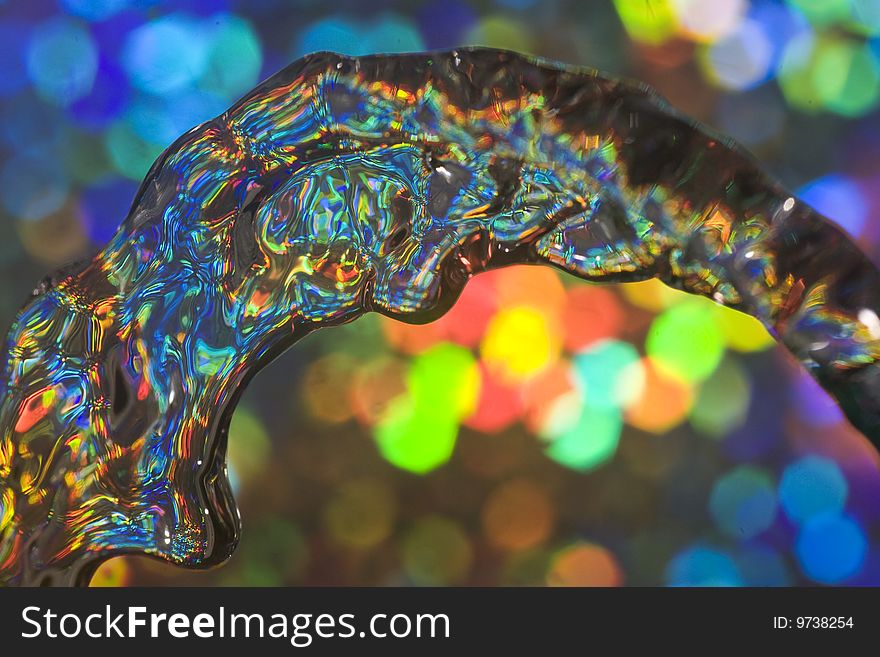 Abstract of flowing water with colourful reflected light. Abstract of flowing water with colourful reflected light