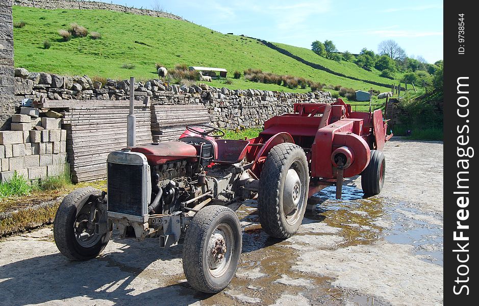 Close-up of old tractor in farm yard on sunny day