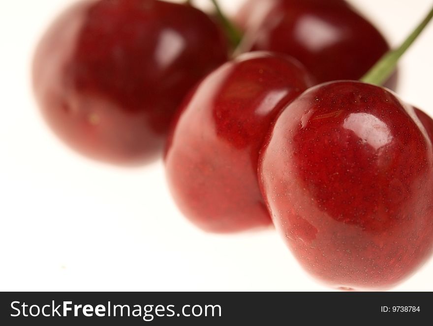 Four ripe fresh cherries close-up. Four ripe fresh cherries close-up