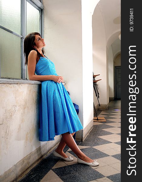 Young woman sitting by the window. Young woman sitting by the window