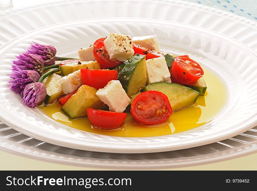 Delicious greek salad on a white plate.