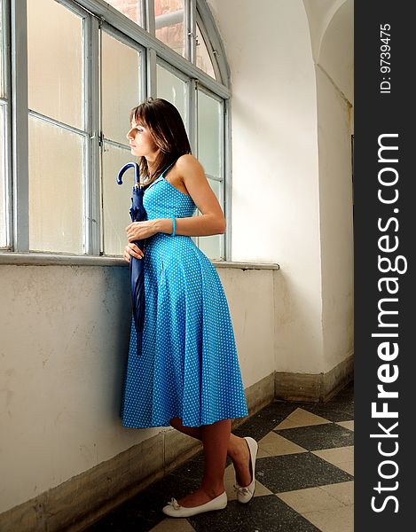 Young woman sitting by the window. Young woman sitting by the window