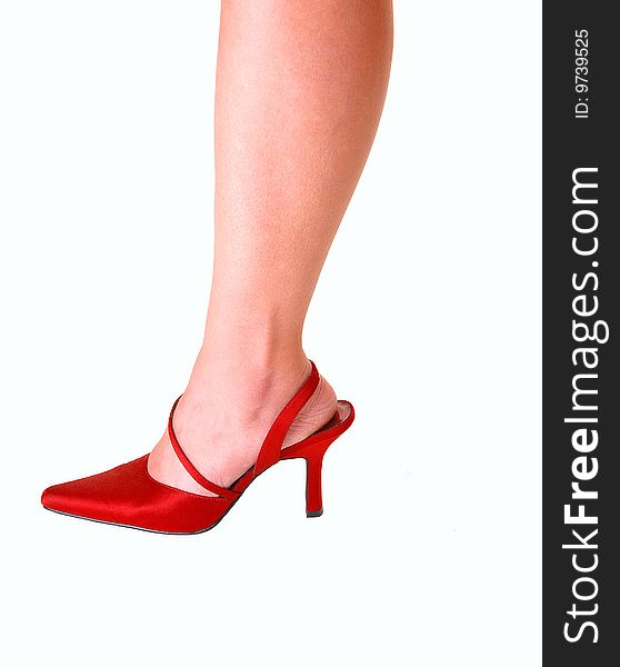 Young womans leg in red high heels for light blue background. Young womans leg in red high heels for light blue background.