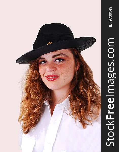 Pretty red haired woman security guard with the big black hat an white blouse on light gray background. Pretty red haired woman security guard with the big black hat an white blouse on light gray background.