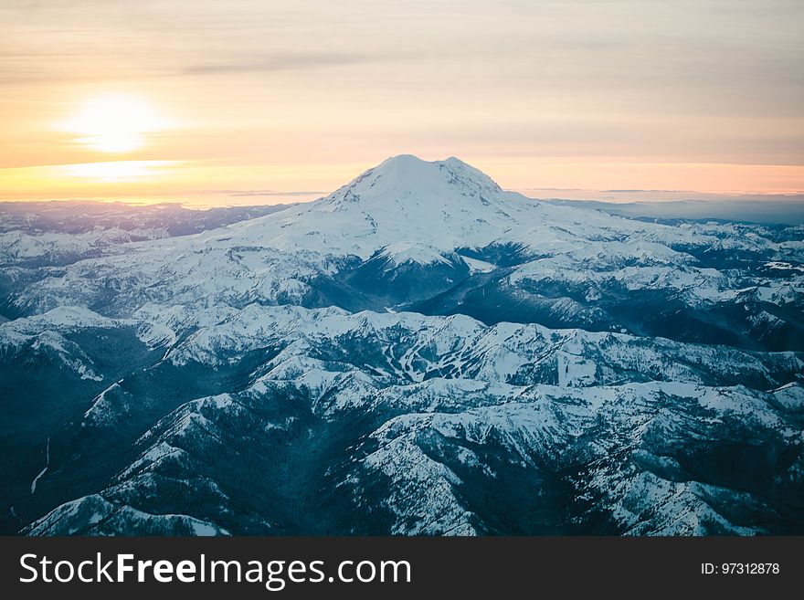 Black Mountain Covered in Snow during Sunset