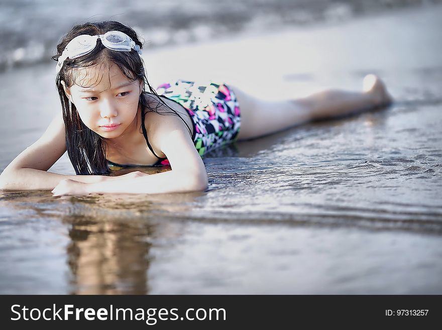 Selective Color Photography of Girl Lying on Beach