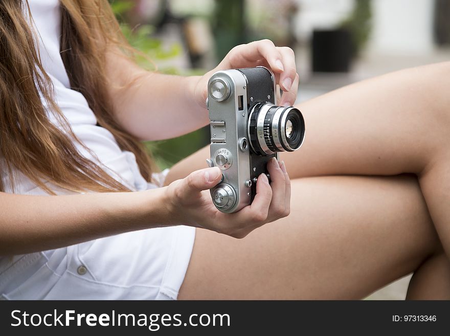 Woman Holding A Gray And Black Adjustable Lens Camera