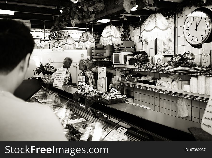 Man Wearing White Shirt in a Cafe in Gray Scale Photography