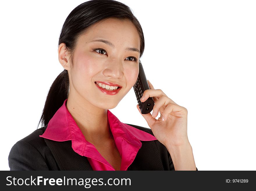 An attractive businesswoman using a phone. An attractive businesswoman using a phone