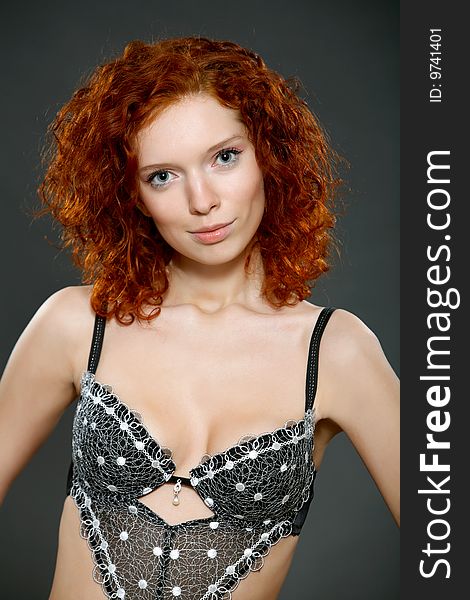 underwear model with red curly hair posing in a studio. underwear model with red curly hair posing in a studio