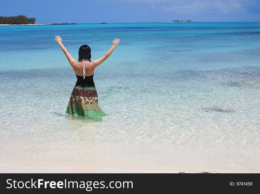 A woman stands in awe of the beautiful Caribbean Ocean and surroundings. Ahhh, this is beautiful, take me on vacation!. A woman stands in awe of the beautiful Caribbean Ocean and surroundings. Ahhh, this is beautiful, take me on vacation!