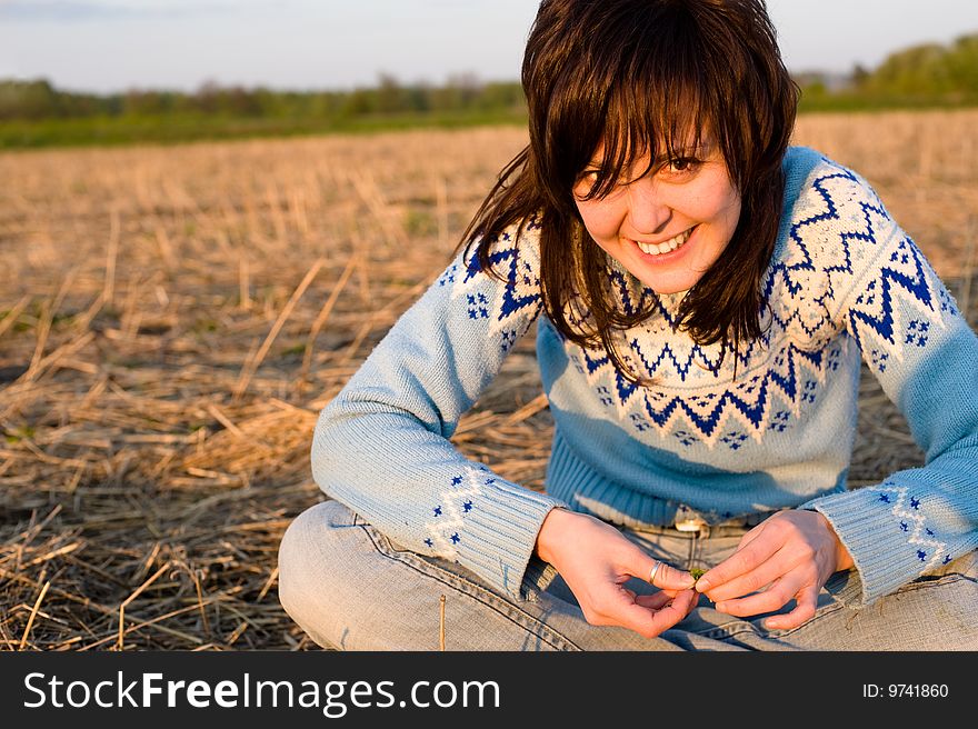 Sunny girl portrait outdoors with a field in the background