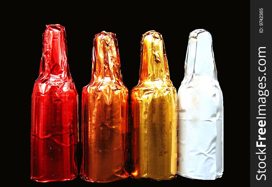 Four liquor chocolates shaped as bottles arranged in a row