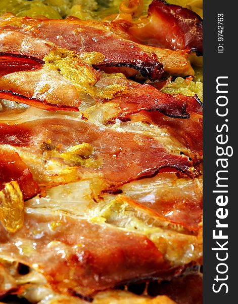 Baked prosciutto with herbs, detail, vertical. Baked prosciutto with herbs, detail, vertical