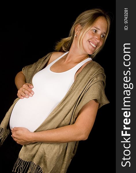 Young smiling pregnant woman holding her tummy. Young smiling pregnant woman holding her tummy