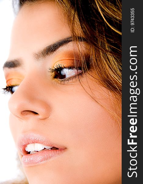 Close up of woman's face looking down on white background