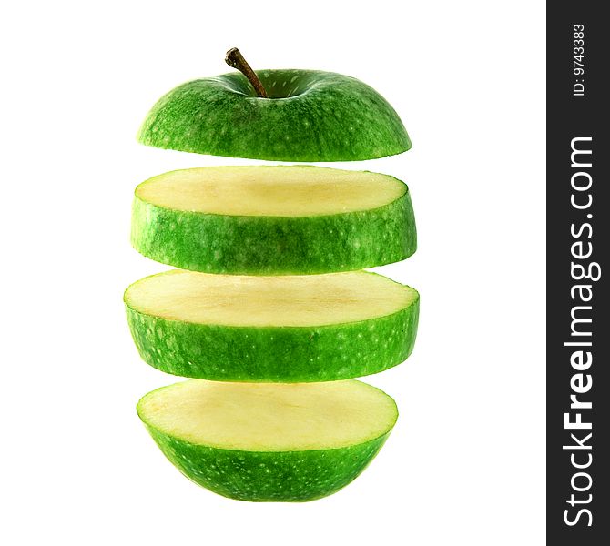 Green apple cut into slices isolated over a white background