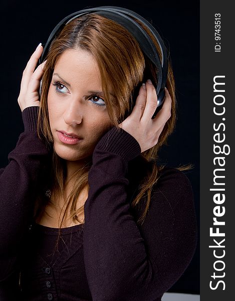 Portrait of young woman listening music