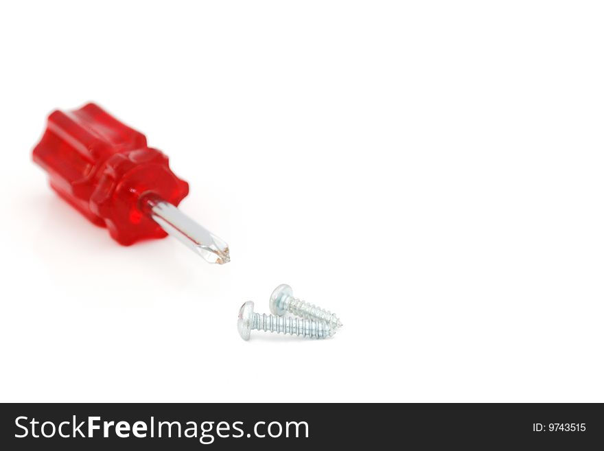 A red cross-head screwdriver and screws isolated on white background