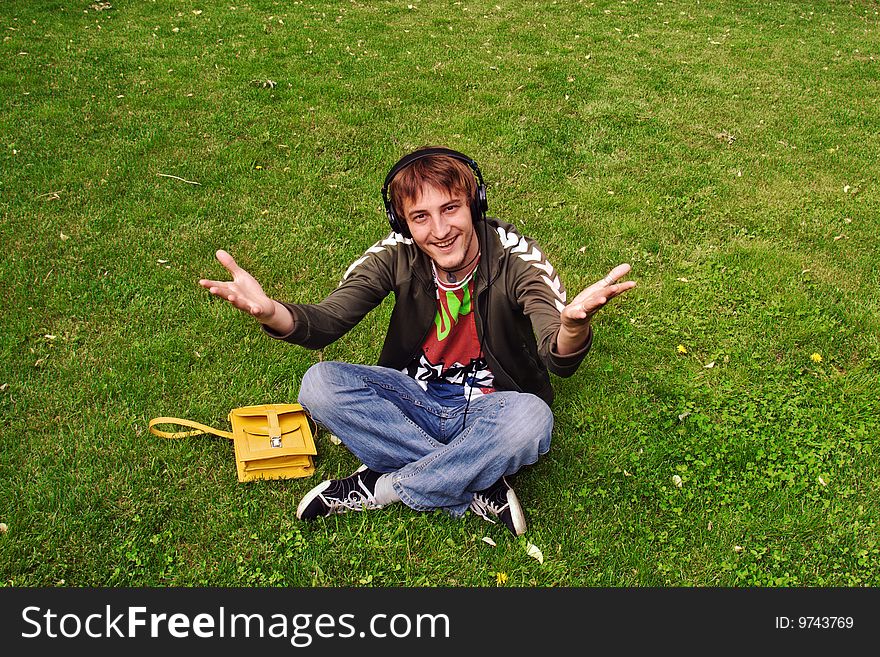 Young man sitting on the grass. Young man sitting on the grass