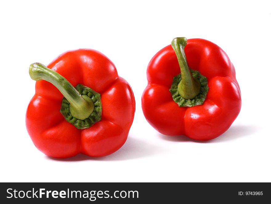 Sweet shiny peppers on white