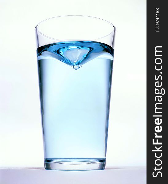 Glass with water on the white background
