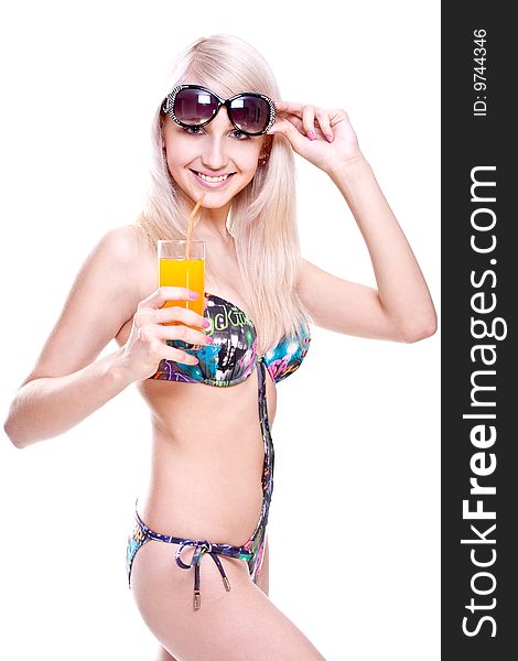 Beautiful women in swimsuit with a glass of juice on a white background isolated