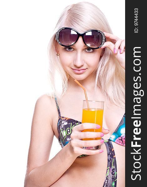 Beautiful women in swimsuit with a glass of juice on a white background isolated