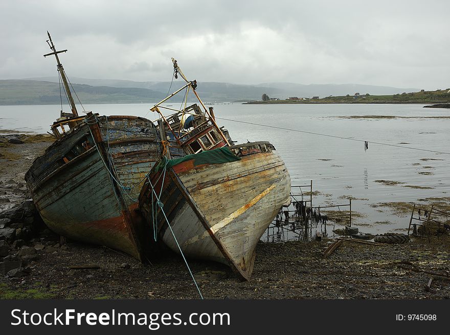 Ship wrecks at low tide by the Scottish coastline