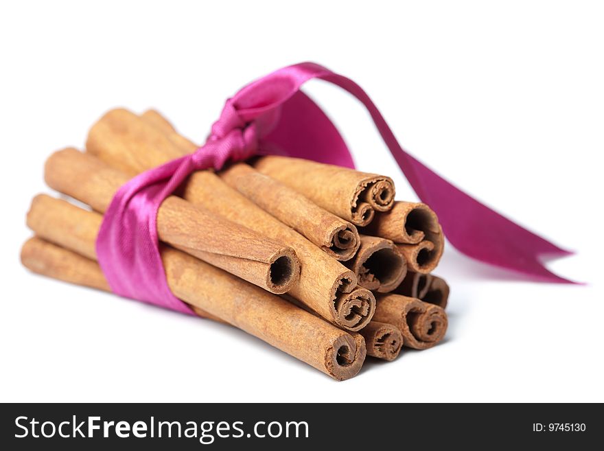 Cinnamon with pink ribbon isolated over white