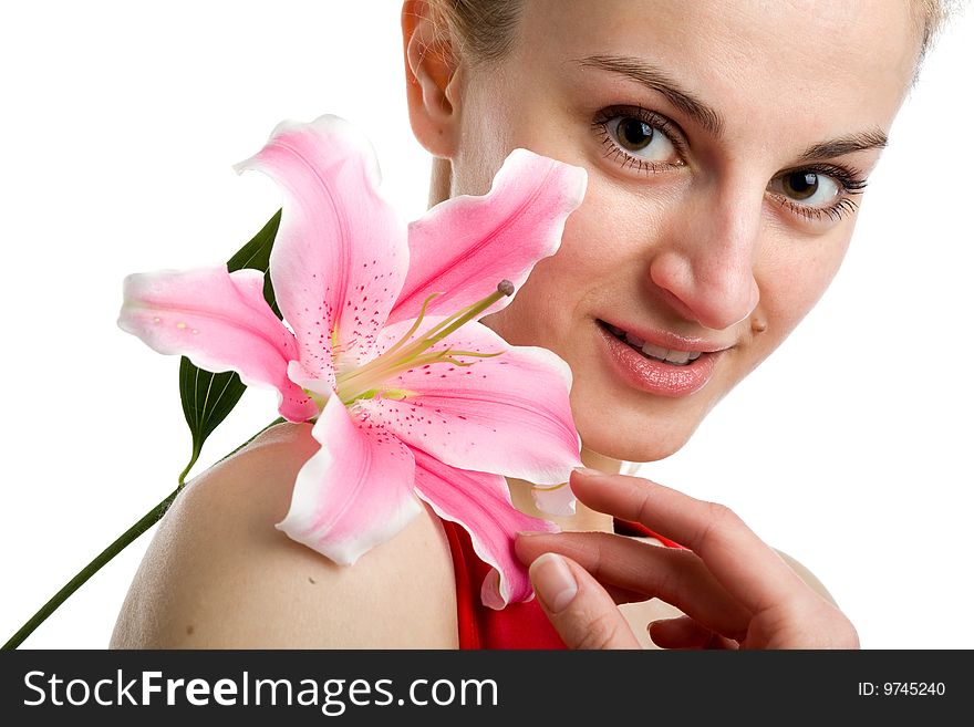 A portrait of a nice girl in red with a pink lily near her face on a white background. A portrait of a nice girl in red with a pink lily near her face on a white background