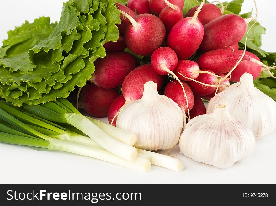 Spring onions, garlic, lettuce and radish bunch on the white background