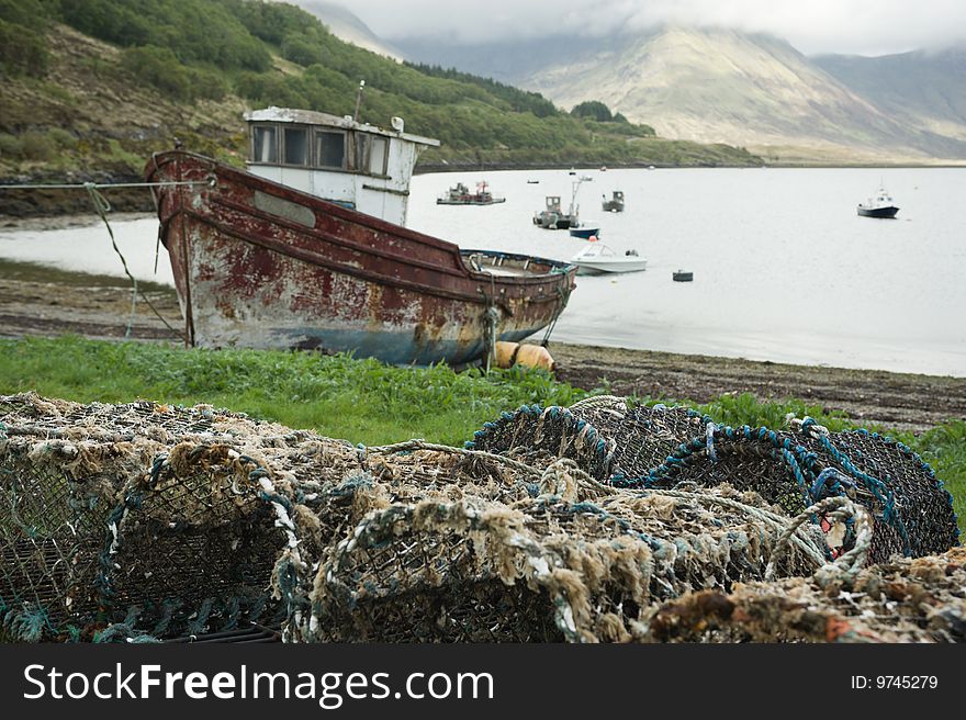 Fishing vessel and creels on shore of lake Slapin, Scotland. Fishing vessel and creels on shore of lake Slapin, Scotland