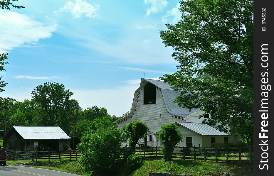 A hightop barn set in rural Tennessee against farm fields. A hightop barn set in rural Tennessee against farm fields