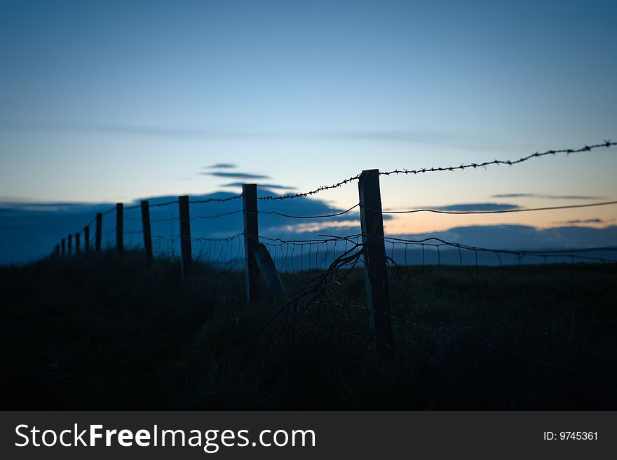 Low key image of a fence near Arisaig, Scotland. Low key image of a fence near Arisaig, Scotland