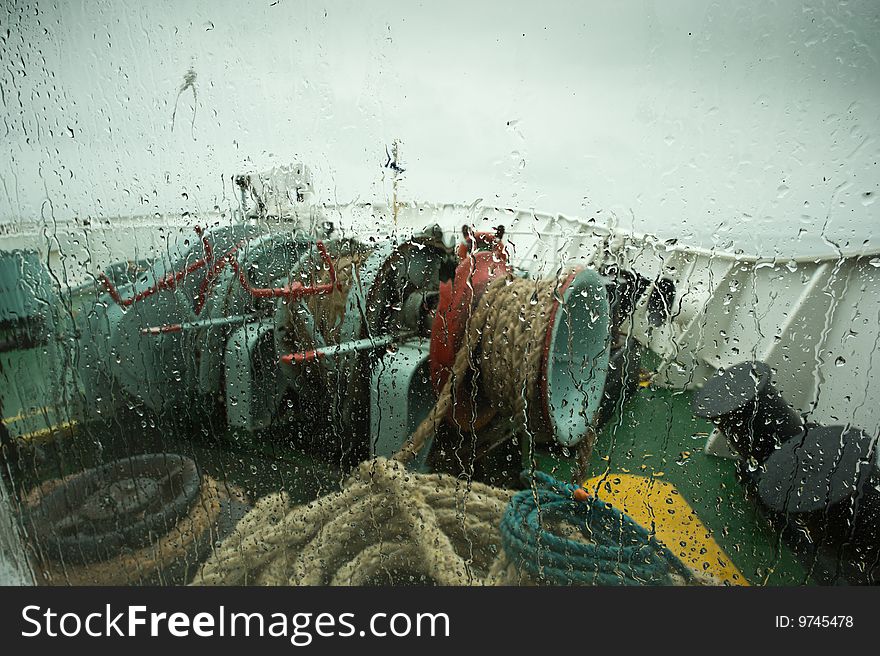 View of the front of a ship  in rainy weather. View of the front of a ship  in rainy weather