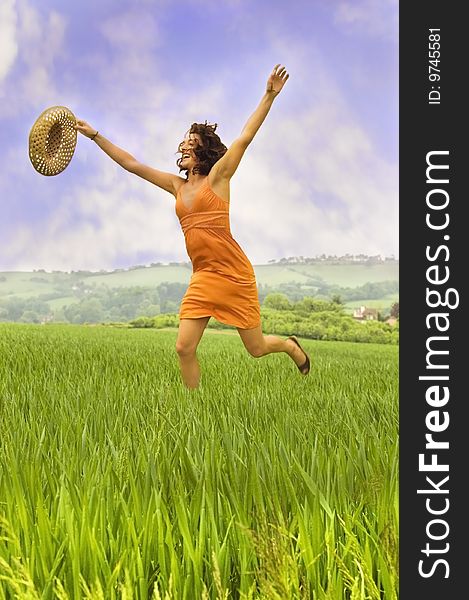 Attractive woman running through a field. Attractive woman running through a field.