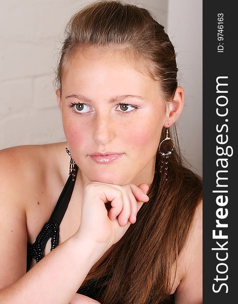 Close up of female teenager against a brick wall. Close up of female teenager against a brick wall