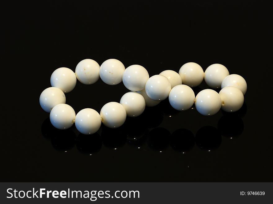 A set of jewelry consisting of a pearl pearl bracelet, isolated on black background