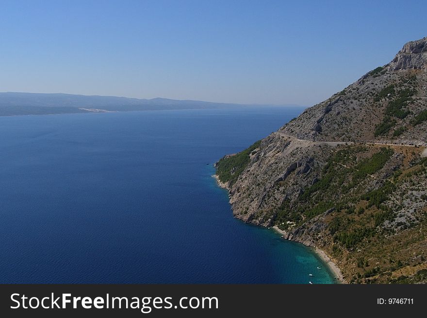 Adriatic, seaside landscape: Makarska Riviera, with mountain descending steeply to the sea, with beautiful beach, and view of Brac Island; Dalmatia - Croatia - Europe

*with space for text (copyspace). Adriatic, seaside landscape: Makarska Riviera, with mountain descending steeply to the sea, with beautiful beach, and view of Brac Island; Dalmatia - Croatia - Europe

*with space for text (copyspace)