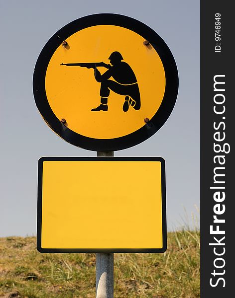 Shooting soldier sign. Add text on yellow blank sign. Warning sign near Danish shooting area.