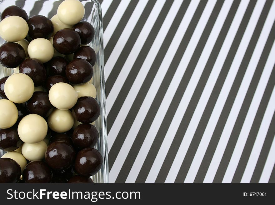 Vanilla and Dark Chocolate balls on a striped background