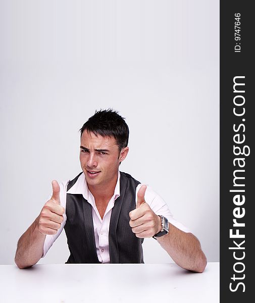 A handsome businessman with thumbs up on an isolated white background