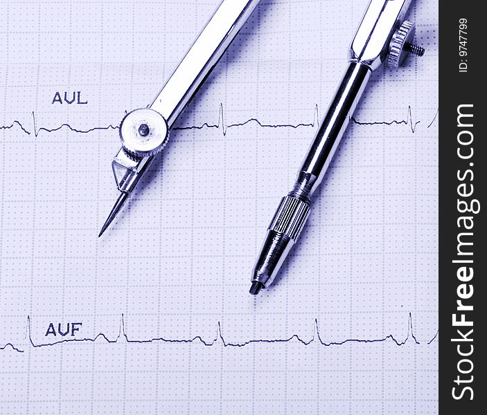 EKG printout and compasses under  monochromatic source