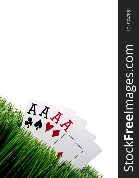 Four ace playing cards in grass