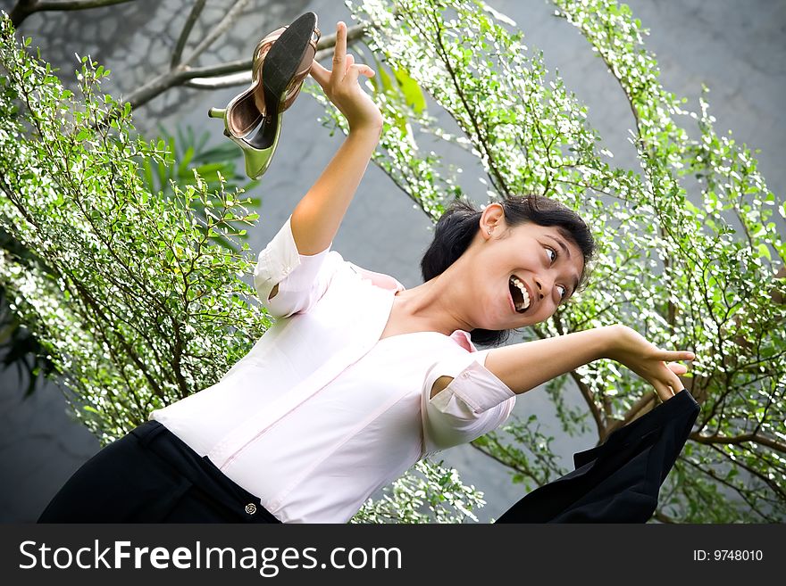 Conceptual portrait of pretty asian businesswoman in outdoors, seems excited after quitting from a stressful office job. Conceptual portrait of pretty asian businesswoman in outdoors, seems excited after quitting from a stressful office job